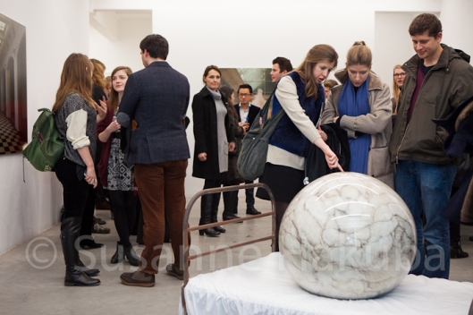 Private view goers fascinated by one of Adeline's creaptures, Ronchini Gallery, London. 